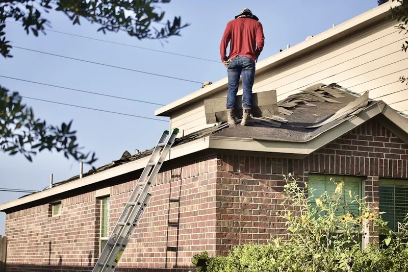Professional roofer working on a residential roof in Smith